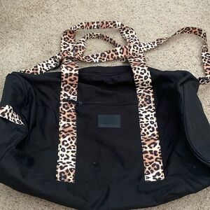 Pink duffel bag with leopard straps